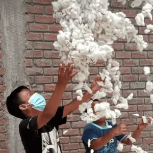 Children playing with Amazon cotton during a visit connected to textile sourcing experiences in Peru