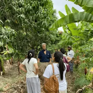 Group of people learning about regenerative agriculture on a textile sourcing experience in Peru