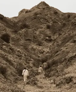 People hiking through a rugged Andean landscape wearing garments made from Naturtex’s sustainable Peruvian textile products.